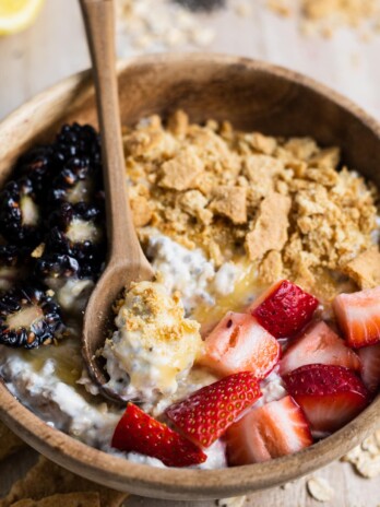 Bowl of overnight oats with lemon curd, fresh berries and graham cracker crumbs