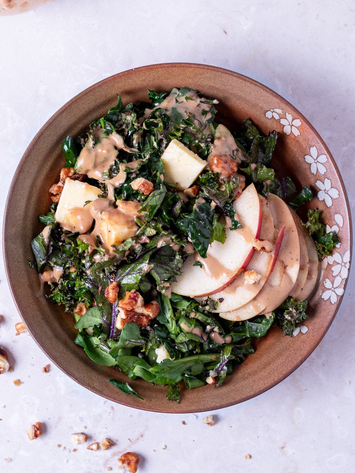 small brown bowls with kale and spinach salad