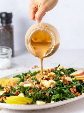 balsamic dressing poured over kale and spinach salad