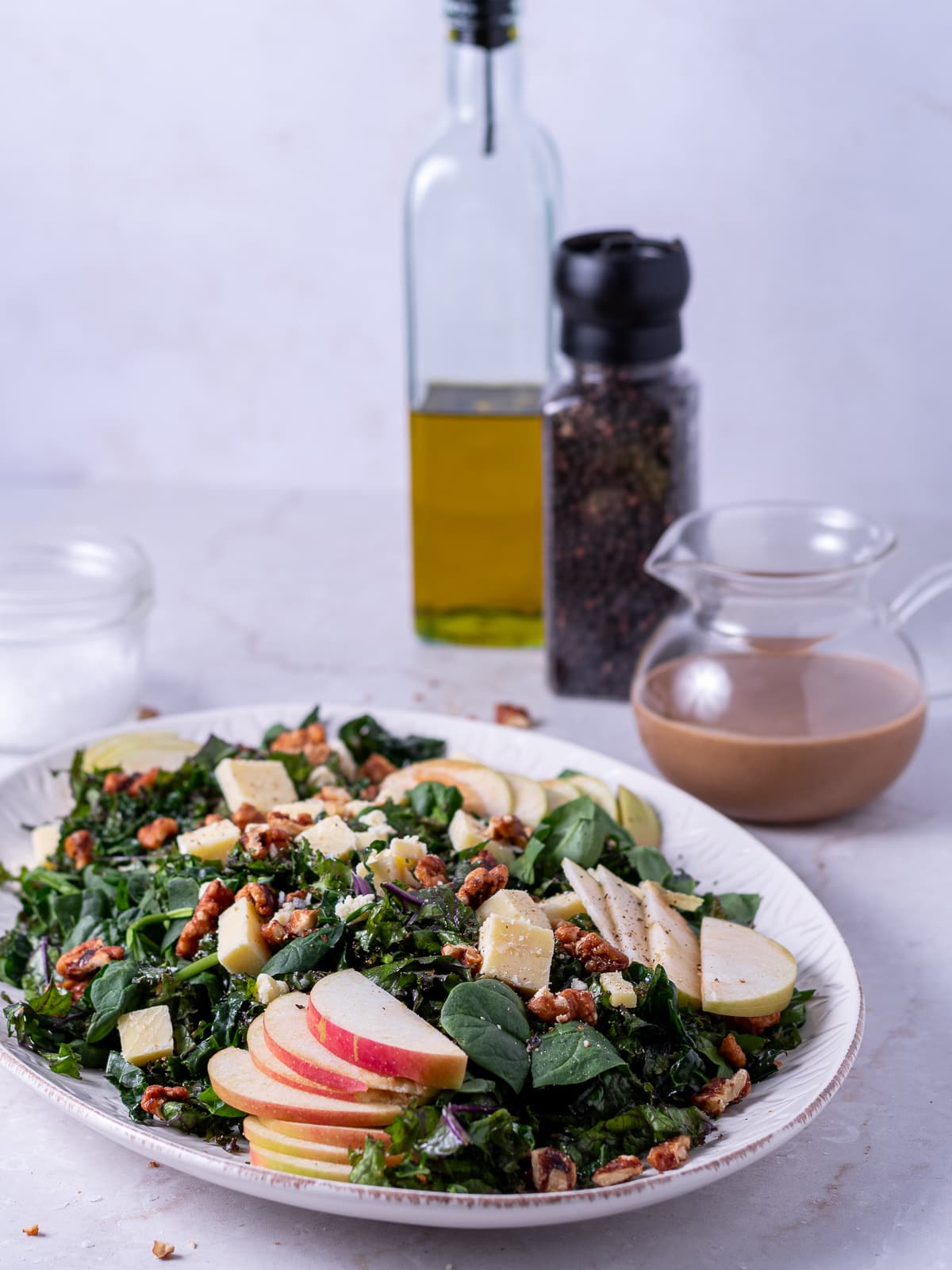kale, apple, walnut and spinach salad with small pot of fig balsamic dressing