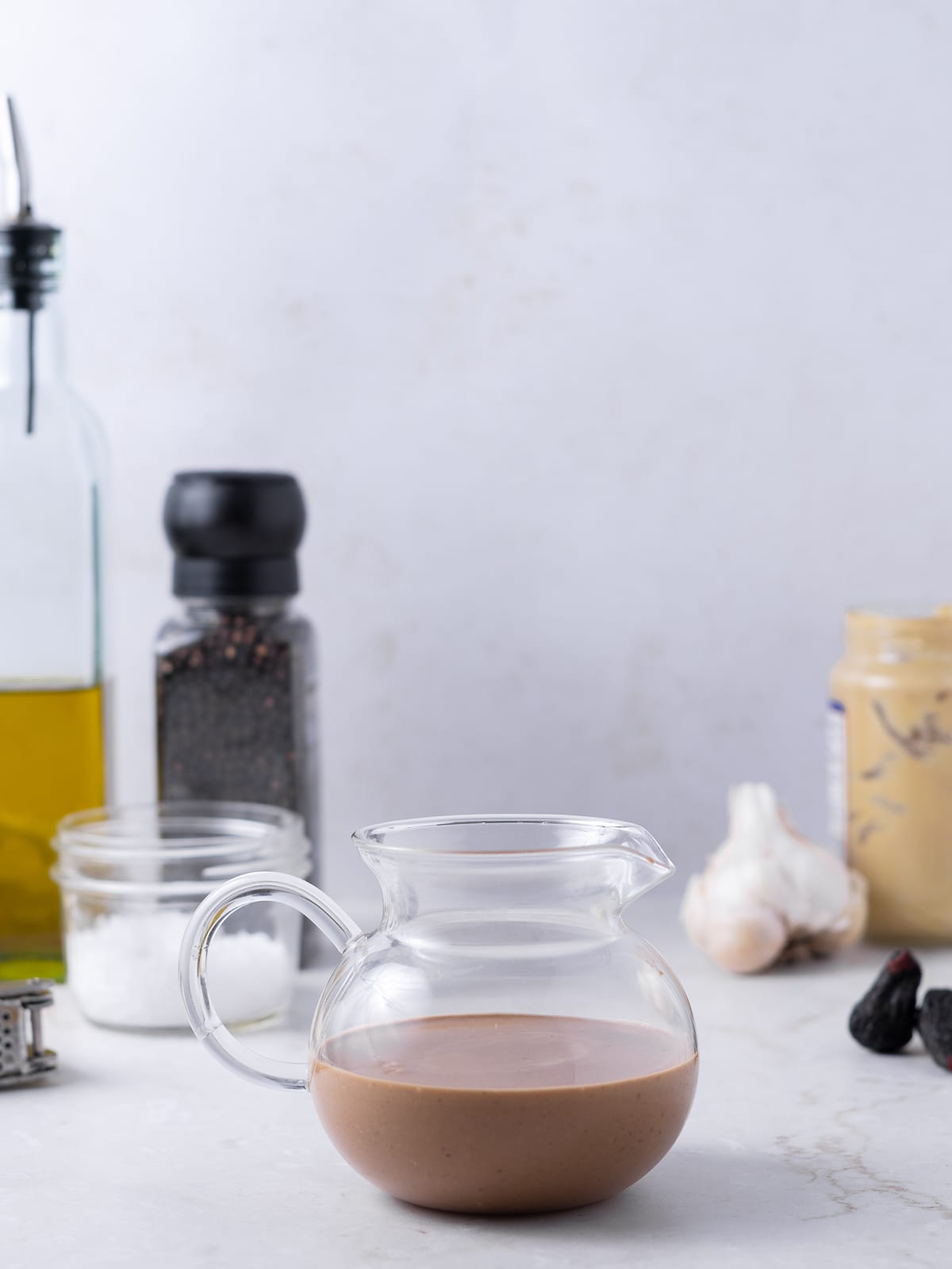 small glass teapot filled with fig balsamic dressing
