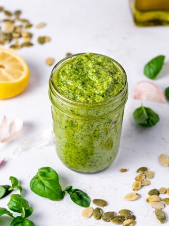 jar of bright green pesto made from fresh basil and pumpkin seeds