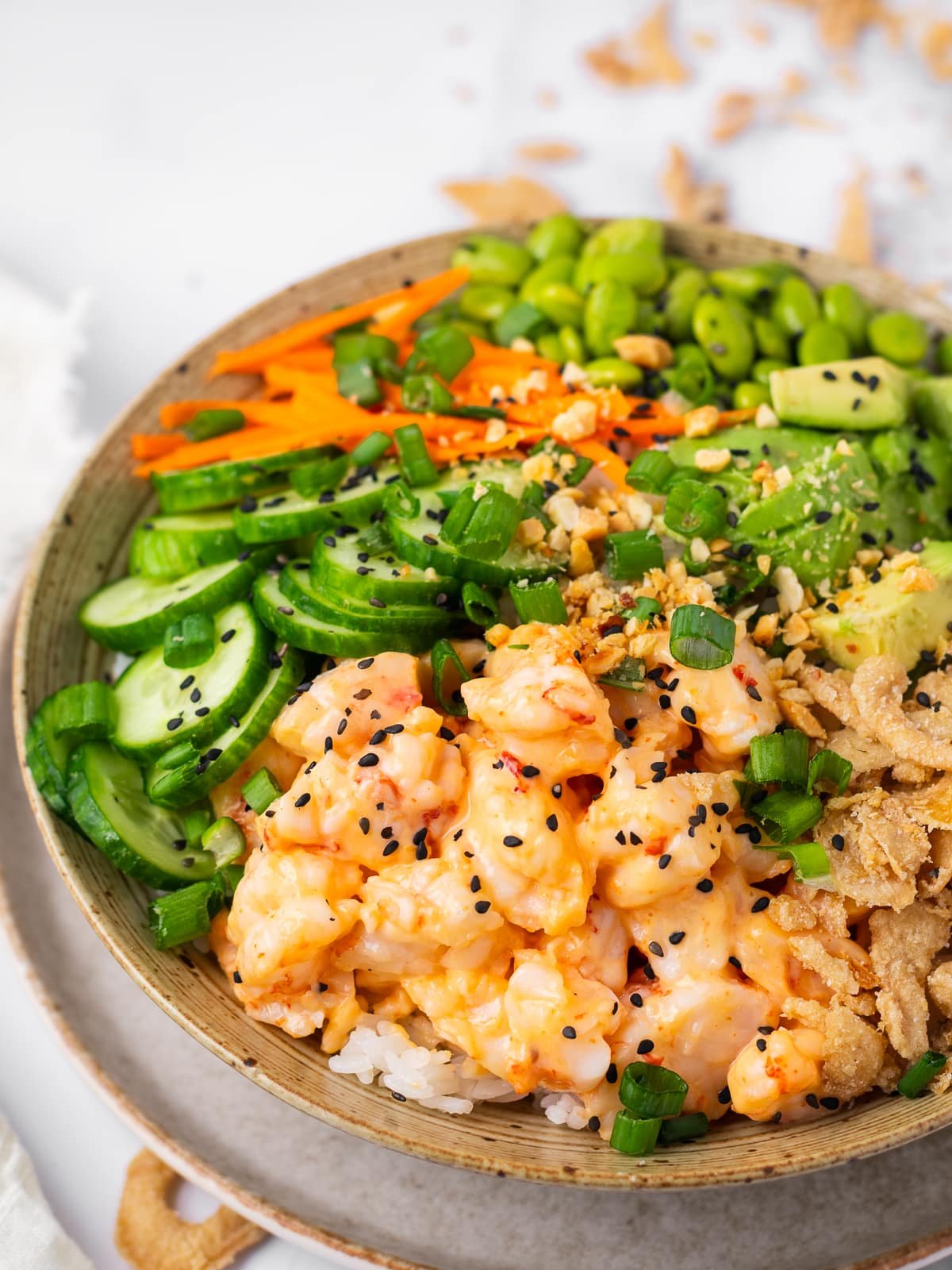 close up view of chopped shrimp tossed with a creamy sweet chili sauce