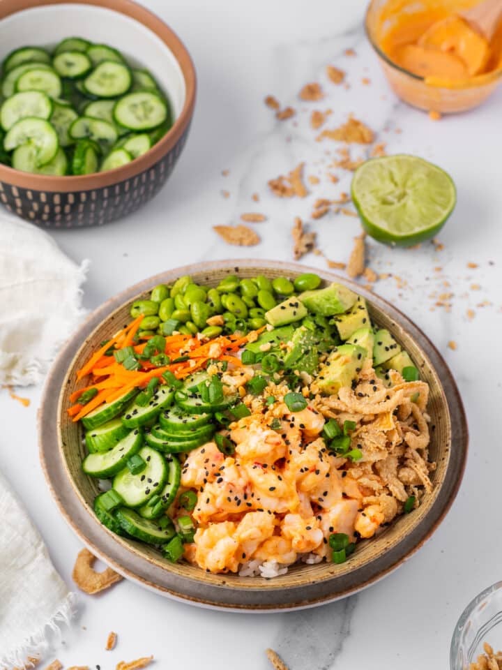 fully assembled shrimp poke bowl with veggies and avocado
