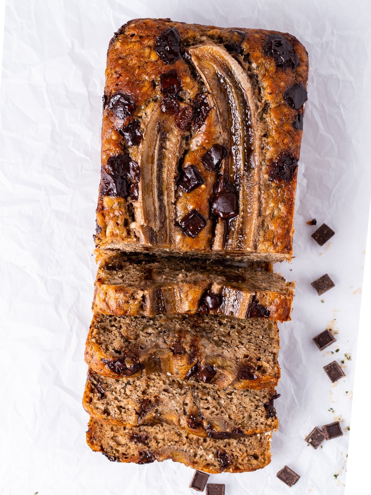 loaf of banana bread with chocolate chunks and a banana on top