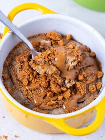 ramekin of biscoff baked oats drizzle with biscoff cookie butter