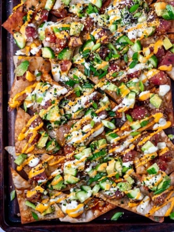sheet pan with crispy wontons, marinated ahi tuna, cucumbers and sauces