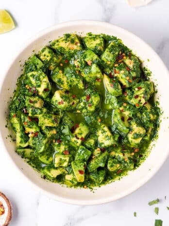 large white bowl with avocado chimichurri topped with red pepper flakes