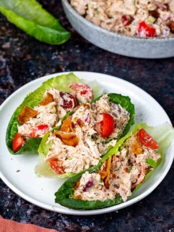 white plate with three lettuce wraps filled with BLT chicken salad