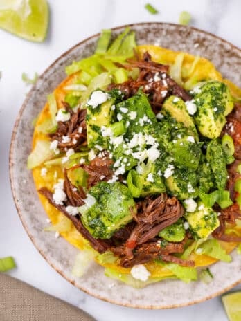 picture of shredded beef tostada with avocado chimichurri