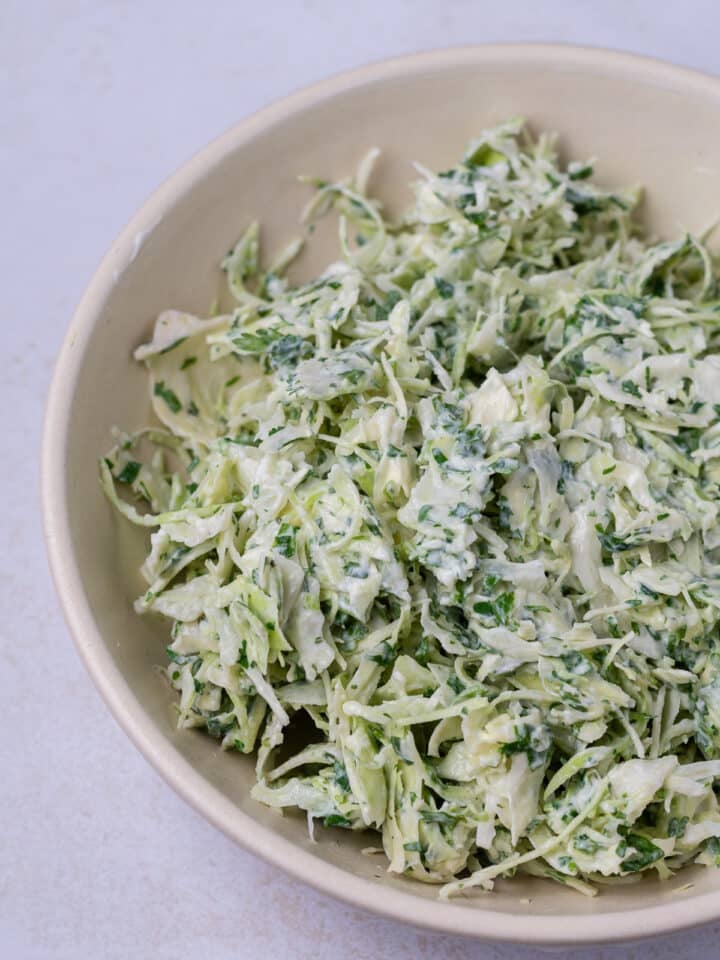 beige bowl with mixed creamy cilantro lime slaw