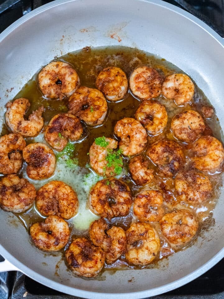 lime juice, lime zest, butter and honey added to shrimp in pan