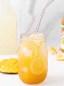 Mason jar with mango puree, lemonade and sparkling water to make a mango mocktail