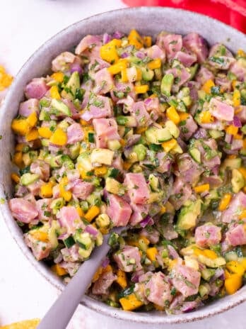 large bowl with a spoon scooping up tuna ceviche