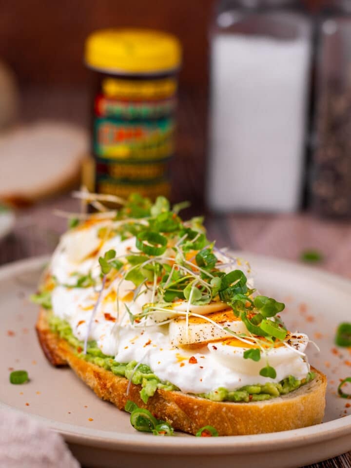 avocado toast with cottage cheese topped with egg and microgreens