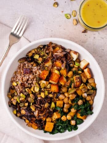 fall farro grain bowl with farro, grilled cheese, fried shallots, kale, squash and chickpeas