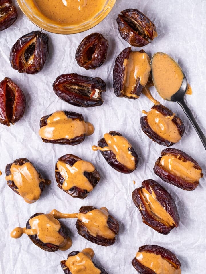 spoon adding peanut butter to the inside of the pitted dates
