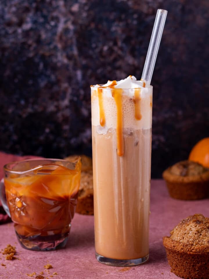 tall glass with iced caramel latte, salted caramel drizzle, small pitcher of caramel, pumpkin muffins