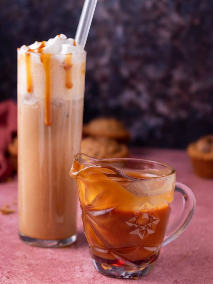 small pitcher of caramel syrup and tall glass of salted caramel latte