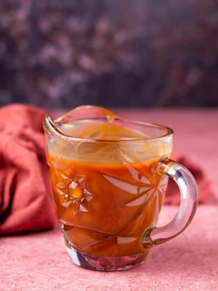 small glass carafe of salted caramel syrup