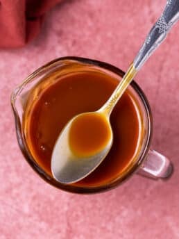 spoon in a small pitcher of salted caramel