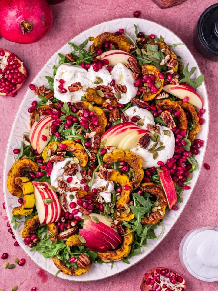 arugula burrata salad with delicata squash, apples, pomegranate, pecans and pepitas