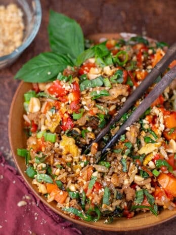 Thai basil chicken fried rice on a plate with chopsticks