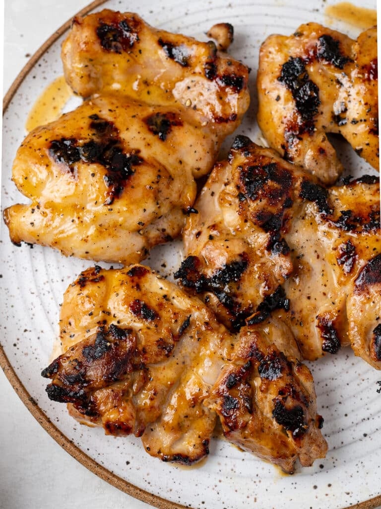 close up view of the grill marks on marinated boneless chicken thighs