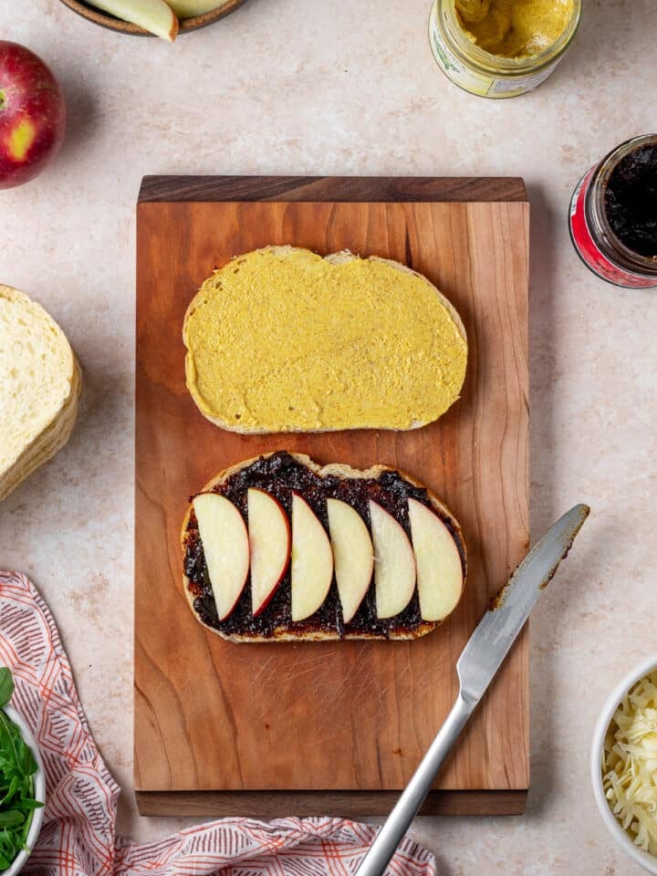 sliced apples placed on fig jam slice of bread