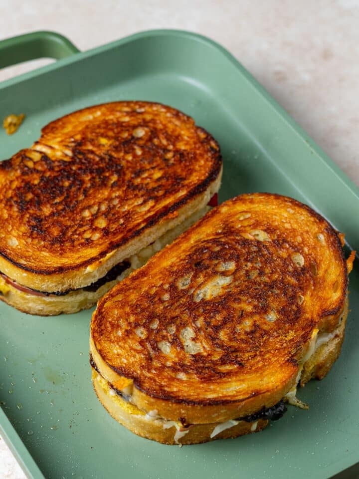 two grilled cheese sandwiches on a griddle