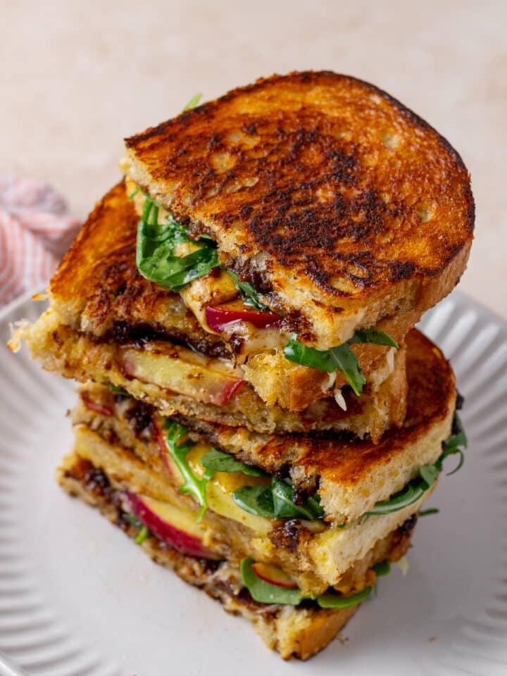 stack of grilled cheese sandwiches with fig and apple and arugula