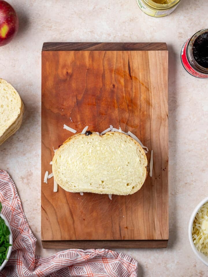 fully assembled sandwich on a wood cutting board, uncooked