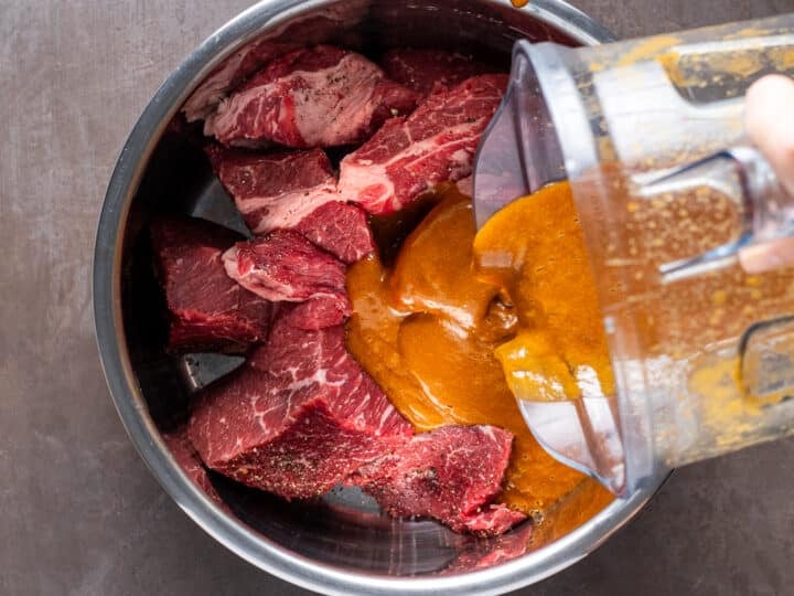 pouring sauce over the meat in the Instant Pot