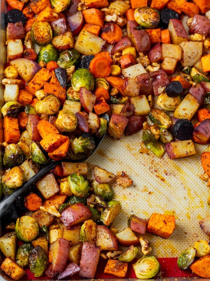 spoon scooping up roasted honey walnut vegetables