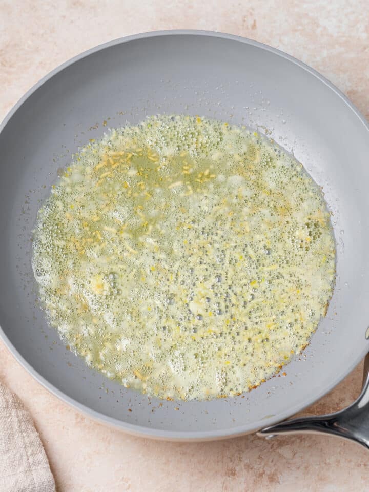 sautéing garlic in a skillet with butter and olive oil