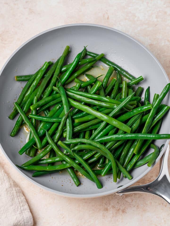 cooked green beans added to the garlic butter