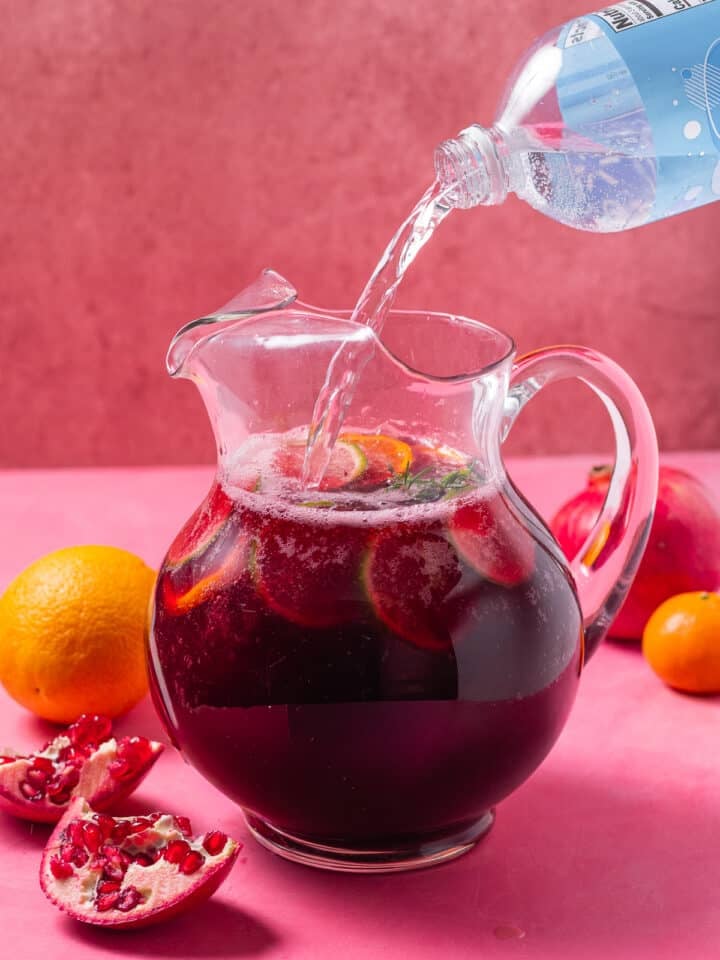 finishing off the drink with club soda