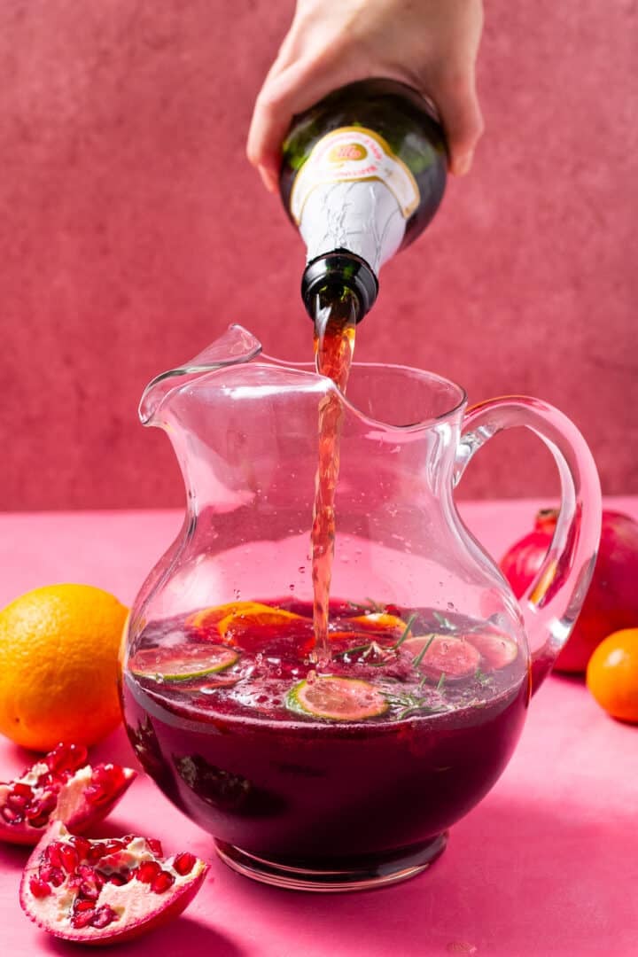 pouring sparkling apple juice in the pitcher