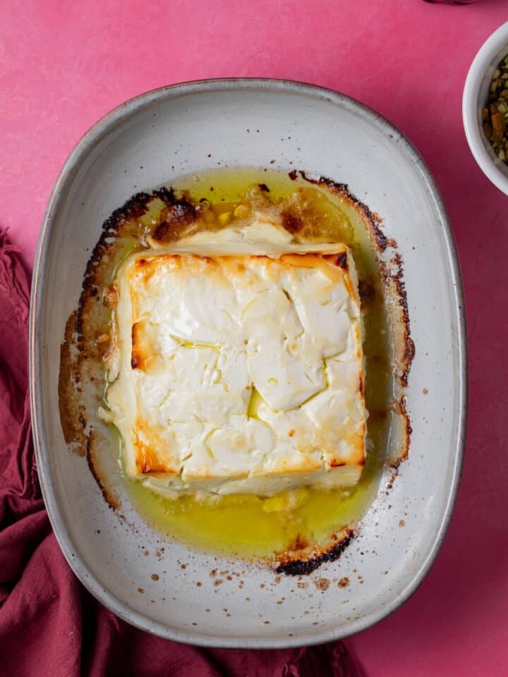 block of feta with caramelized edges in a baking dish