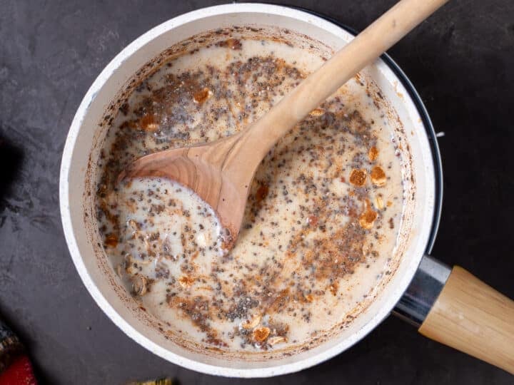 wooden spoon stirring milk into the mixture