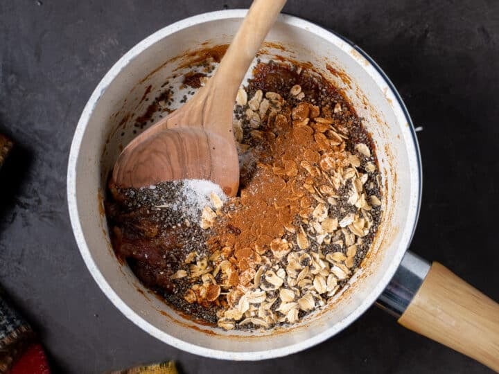 oats, chia seeds, cinnamon and salt added to the saucepan