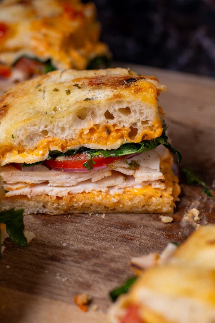 chicken focaccia sandwich with tomato, arugula, cheese and sun-dried tomato aioli