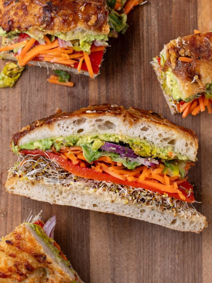 rainbow veggie sandwich with sprouts, roasted red pepper, carrots, cucumber, red onion and avocado