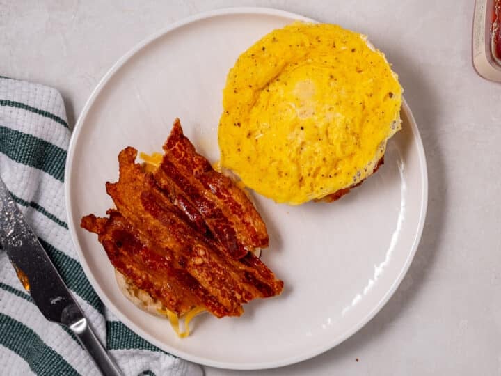 egg on one half and bacon on the other half of an english muffin