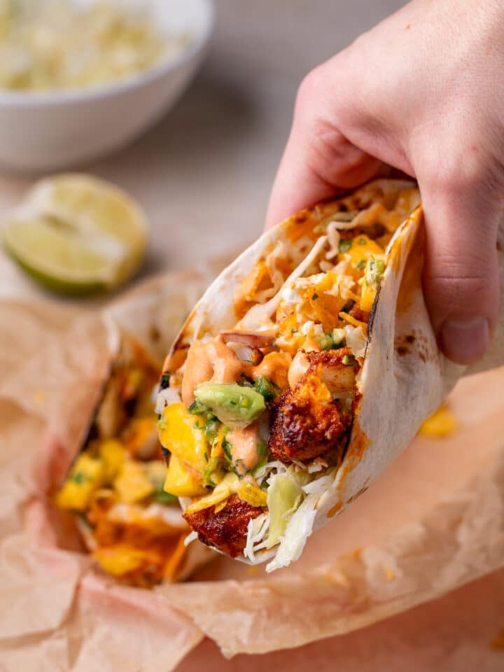 hand holding a fish taco