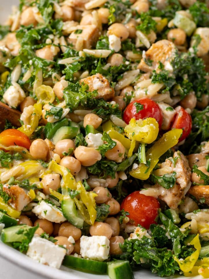 close up view of a chicken and chickpea salad with feta and tomatoes