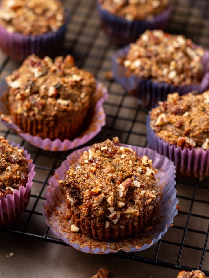 close up view of a date muffin with pecan topping