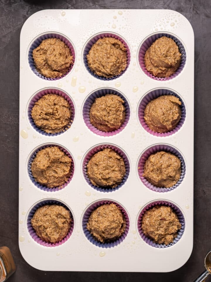 muffin tin filled with date muffin batter