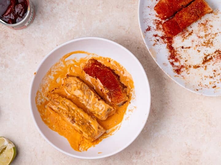 seasoned halibut fillets getting tossed in chipotle aioli