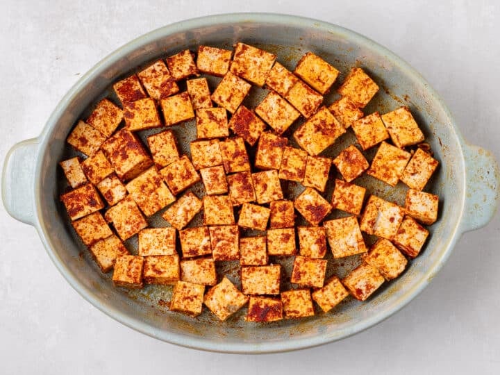 seasoned cubes arranged in a baking dish before cooking